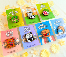 Load image into Gallery viewer, A wooden pin shaped like a bear holding a cup of boba tea. The bear has a cute, cartoonish design with rounded features and a friendly expression. The cup of boba tea is detailed with tiny tapioca pearls at the bottom, and the bear appears to be happily sipping through a straw. The wood has a natural grain, adding a rustic charm to the design
