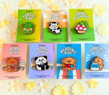 Load image into Gallery viewer, A wooden pin shaped like a bear holding a cup of boba tea. The bear has a cute, cartoonish design with rounded features and a friendly expression. The cup of boba tea is detailed with tiny tapioca pearls at the bottom, and the bear appears to be happily sipping through a straw. The wood has a natural grain, adding a rustic charm to the design.
