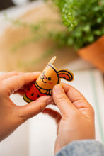 Load image into Gallery viewer, Belugabee Bamboo Sticker: Demonstrating durability and flexibility – Bunny and Watermelon design showcased in a bent position. Elevate your style with this eco-friendly 3x3-inch sticker. 🐰🍉 #BambooSticker #FlexibilityAndDurability #BunnyAndWatermelon

