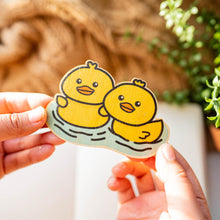 Load image into Gallery viewer, Belugabee Bamboo Sticker: Adorable scene of two duckies swimming side by side, captured on eco-friendly bamboo. Elevate your style with this charming 3x3-inch sticker. 🦆🌿 #BambooSticker #Duckies #CuteWildlife
