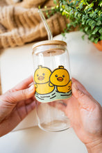 Load image into Gallery viewer, Belugabee Bamboo Sticker: Adorable scene of two duckies swimming side by side, enhancing the charm of your glass cup. Elevate your style with this eco-friendly 3x3-inch bamboo sticker. 🦆🌿 #BambooSticker #Duckies #GlassCupDecor
