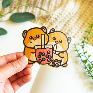 Belugabee Bamboo Sticker: Adorable duo of hamsters holding boba cups, crafted on eco-friendly bamboo. Elevate your style with this charming 3x3-inch sticker. 🐹🥤🌿 #BambooSticker #HamsterBobaDesign #CuteDecor