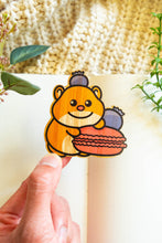 Load image into Gallery viewer, Belugabee Hamster Macaron Bamboo Sticker Alt Text: Cute hamster holding a macaroon with a playful blueberry perched on its head, intricately designed on eco-friendly bamboo. 🐹🍬 #BambooSticker #HamsterMacaronDesign #AdorableDecor
