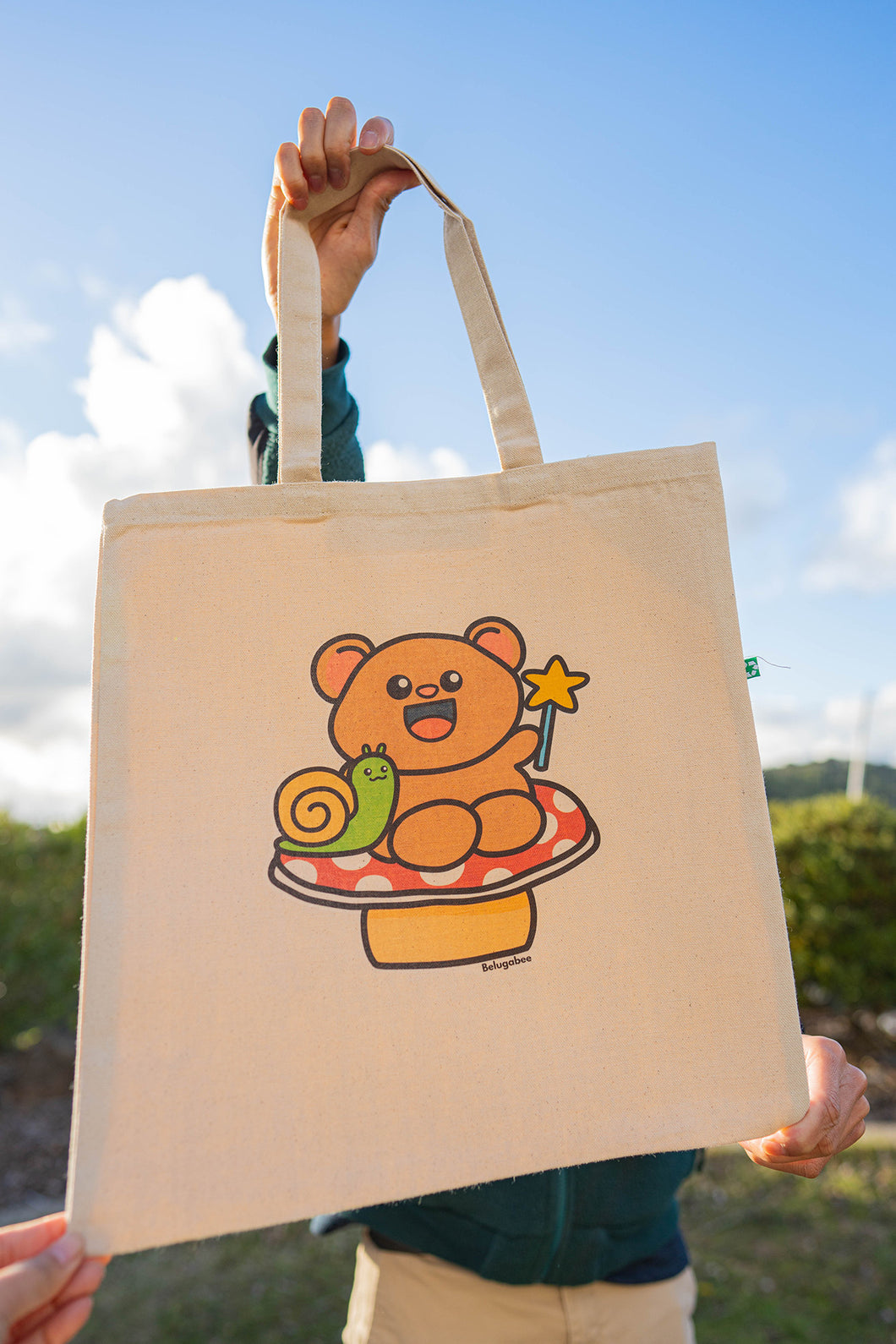 A Fairy Bear Tote Bag is a whimsical accessory that combines the enchanting allure of fairies with the charm of bears. These tote bags often feature illustrations or designs depicting bears adorned with fairy wings, set against magical or forested backdrops. Crafted from durable materials like canvas or jute, they are both functional and stylish, suitable for carrying everyday essentials or serving as a unique gift for nature and fantasy enthusiasts.