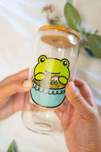 Load image into Gallery viewer, Belugabee Bamboo Sticker: Whimsical scene of a frog slurping noodles from a blue ramen bowl, enhancing the charm of your glass cup. Elevate your style with this eco-friendly and delightful 3x3-inch bamboo sticker. 🐸🍜 #BambooSticker #FrogRamen #GlassCupDecor
