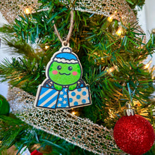 Load image into Gallery viewer, Belugabee Wooden Holiday Ornament: Adorable design of a turtle wearing a blue beanie, holding three blue presents. Elevate your festive decor with this charming and whimsical 3x3-inch wooden ornament. 🐢🎁🔵 #WoodenHolidayOrnament #GiftingTurtle #FestiveDecor
