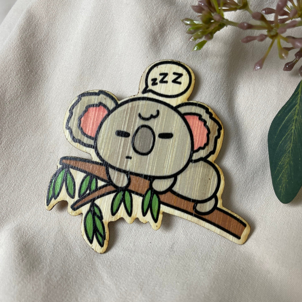 Belugabee Bamboo Sticker: Adorable koala peacefully sleeping on a tree branch, captured with a comic graphic 'zzz' for extra charm. Elevate your style with this eco-friendly 3x3-inch sticker. 🐨🌿 #BambooSticker #CrankyKoala #SleepingKoala