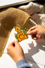 Load image into Gallery viewer, A heartwarming bamboo sticker featuring a kangaroo mother and her baby, adding a touch of wildlife love to your belongings. 🦘💚 #KangarooSticker #BambooArt #WildlifeCharm
