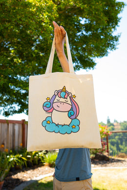 A dreamy tote bag featuring a majestic unicorn surrounded by sparkling stars and a soft, magical aura. This eco-friendly bag has a whimsical, hand-drawn design, perfect for unicorn lovers and everyday adventures! 🦄✨💖