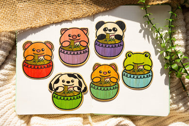 A cute, smiling bowl of ramen with steaming noodles, topped with eggs, narutomaki, and green onions. This eco-friendly bamboo sticker has a cozy, hand-drawn style, perfect for decorating laptops, water bottles, and notebooks