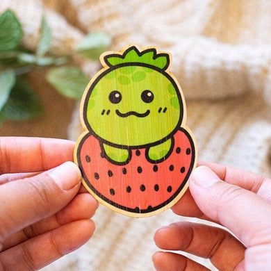 ustration of a turtle with a strawberry-patterned shell on an eco-friendly bamboo sticker.