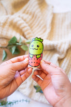 Load image into Gallery viewer, ustration of a turtle with a strawberry-patterned shell on an eco-friendly bamboo sticker.
