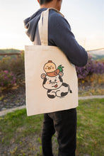 Load image into Gallery viewer, A sturdy canvas tote bag featuring an adorable illustration of a cow and a rooster. The cow has a gentle, friendly expression, with the rooster perched confidently on its back. The design is colorful and playful, set against a neutral background that highlights the characters. Perfect for carrying groceries, books, or daily essentials with a touch of farmyard charm
