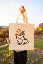Load image into Gallery viewer, A sturdy canvas tote bag featuring an adorable illustration of a cow and a rooster. The cow has a gentle, friendly expression, with the rooster perched confidently on its back. The design is colorful and playful, set against a neutral background that highlights the characters. Perfect for carrying groceries, books, or daily essentials with a touch of farmyard charm
