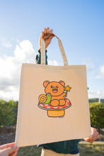 Load image into Gallery viewer, A Fairy Bear Tote Bag is a whimsical accessory that combines the enchanting allure of fairies with the charm of bears. These tote bags often feature illustrations or designs depicting bears adorned with fairy wings, set against magical or forested backdrops. Crafted from durable materials like canvas or jute, they are both functional and stylish, suitable for carrying everyday essentials or serving as a unique gift for nature and fantasy enthusiasts.
