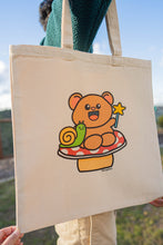 Load image into Gallery viewer, A Fairy Bear Tote Bag is a whimsical accessory that combines the enchanting allure of fairies with the charm of bears. These tote bags often feature illustrations or designs depicting bears adorned with fairy wings, set against magical or forested backdrops. Crafted from durable materials like canvas or jute, they are both functional and stylish, suitable for carrying everyday essentials or serving as a unique gift for nature and fantasy enthusiasts.
