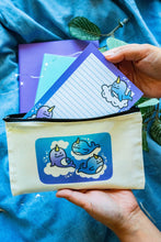 Load image into Gallery viewer, Belugabee Dreamy Narwhal Pencil Pouch: Whimsical design featuring three narwhals on clouds in shades of purple and blue. Elevate your organization with this enchanting 9x5-inch cotton canvas pouch. 🐳✨ #NarwhalPencilPouch #DreamyDesign #CuteStationery
