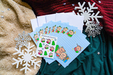 Load image into Gallery viewer, Holiday Letter Set Reveal: Join the excitement of unboxing the Holiday Bear stationery, uncovering the mini matte sticker sheet, writing paper, and self-sealing envelopes for a festive letter-writing experience. 🎁🐻💌
