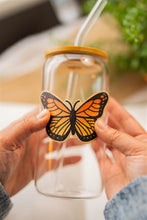 Load image into Gallery viewer, Monarch Butterfly Bamboo Sticker on Glass Cup - Artistic view displaying the beauty of the butterfly sticker adhered to a glass cup.
