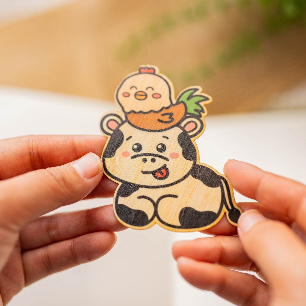 Belugabee Bamboo Wood Sticker: Whimsical image featuring a smiling cow with a rooster perched on its head. Elevate your style with this adorable 3x3-inch eco-friendly sticker. 🐮🐓 #BambooWoodSticker #CowAndRooster #SmilingAnimalDesign