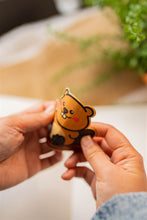 Load image into Gallery viewer, Bamboo Sticker of Beaver being bent to show durability and flexibility of bamboo stickers
