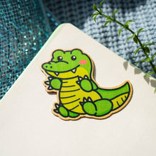 Load image into Gallery viewer, Belugabee Bamboo Sticker: Striking green crocodile design, adding a touch of wild charm to your style. Elevate your accessories with this eco-friendly 3x3-inch bamboo sticker. 🐊🌿 #BambooSticker #GreenCrocodile #NatureInspiredDesign
