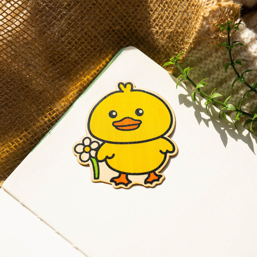 Belugabee Bamboo Sticker: Adorable design of a duck holding a vibrant flower, crafted on eco-friendly bamboo. Elevate your style with this charming 3x3-inch sticker. 🦆🌸 #BambooSticker #DuckAndFlower #CuteDesign