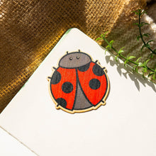 Load image into Gallery viewer, Ladybug Bamboo Sticker perched on a vibrant leaf, showcasing its whimsical charm. 🐞🌿
