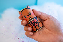 Load image into Gallery viewer, Belugabee Bamboo Sticker: Demonstrating durability and flexibility – Adorable brown bear enjoying chunky boba, bending the sticker to showcase its eco-friendly resilience. Elevate your style with this 3x3-inch sticker. 🐻🍵 #BambooSticker #ChunkyBobaBear #FlexibilityAndDurability

